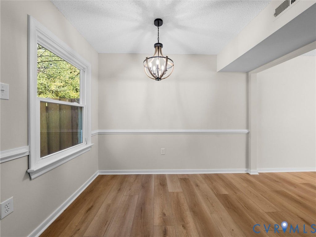 406 Alamosa Drive, Henrico, VA 23075 Room featuring wood-finish flooring, wainscoting, a single-hung window, and a multi-arm orb-style light fixture