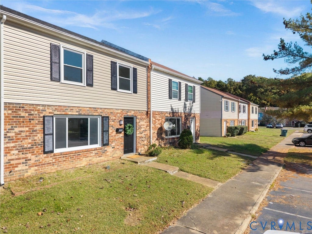 406 Alamosa Drive, Henrico, VA 23075 Multi-level exterior featuring a brick and vinyl siding faade, dark window shutters, and a concrete walkway
