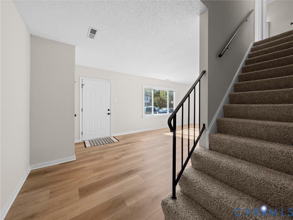 406 Alamosa Drive, Henrico, VA 23075 Entryway featuring wood-finish flooring, a neutral color palette, and a staircase with carpeted treads and a metal handrail