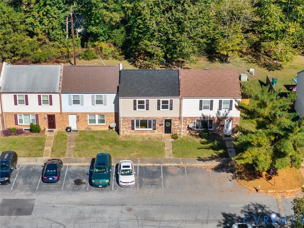 406 Alamosa Drive, Henrico, VA 23075 Multi-level townhouse exterior featuring a combination brick and siding facade, asphalt shingle roofing, and dedicated surface parking