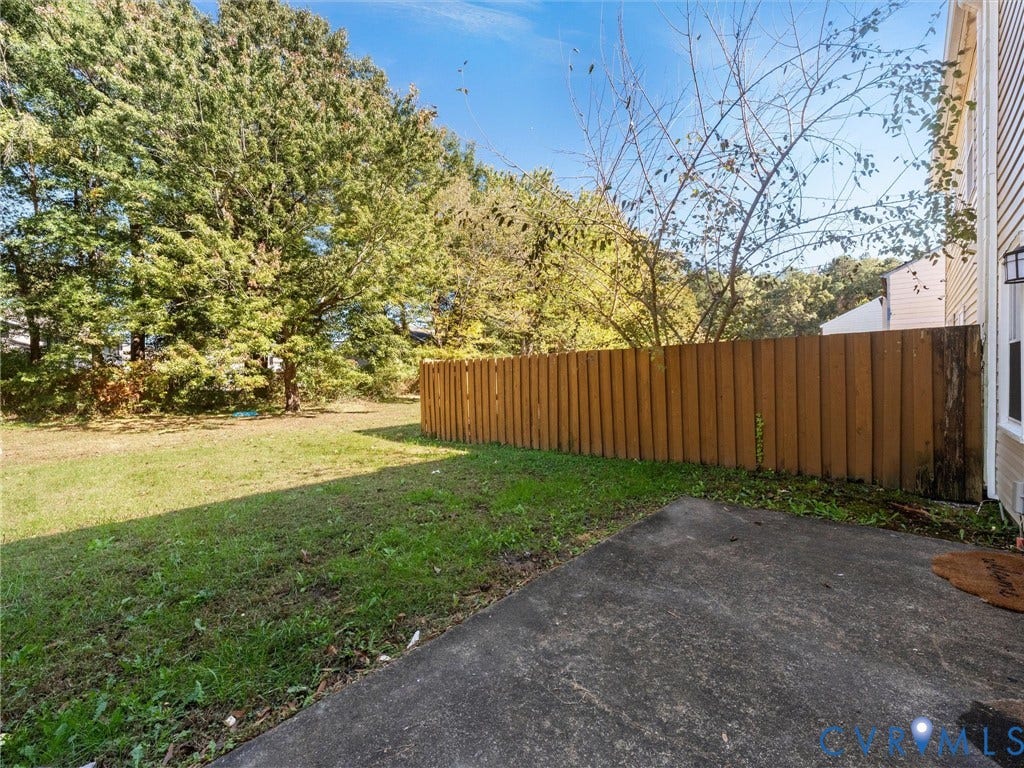 406 Alamosa Drive, Henrico, VA 23075 Rear yard featuring a concrete patio, wood-finish privacy fencing, and mature trees