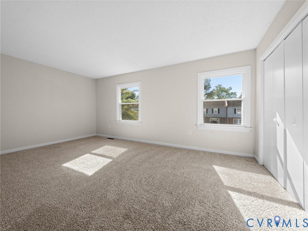 406 Alamosa Drive, Henrico, VA 23075 Room featuring wall-to-wall carpeting, dual windows, neutral paint, and built-in closet storage with double-panel doors