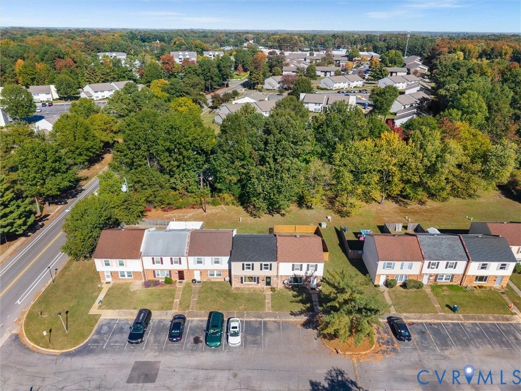 406 Alamosa Drive, Henrico, VA 23075 Aerial perspective featuring multi-story residential structures with gabled rooflines, brick facades, paved surface parking, and manicured grounds