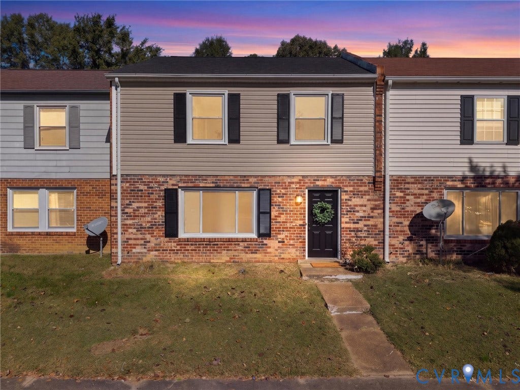 406 Alamosa Drive, Henrico, VA 23075 Two-story townhouse exterior featuring a multi-material facade of brick and vinyl siding, shutters on all windows, and a concrete front walkway