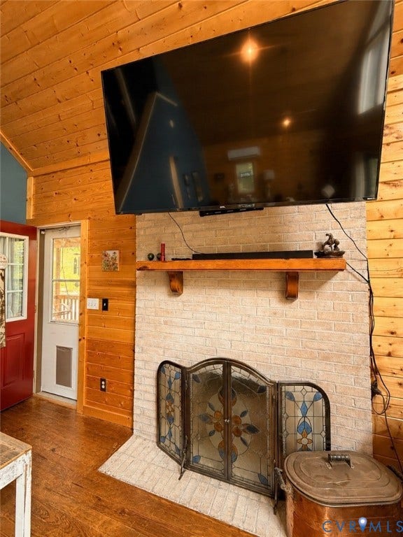 65 Cubbley Road, Hot Springs, VA 24445 Tongue-and-groove wood wall paneling, light-toned brick fireplace surround, natural wood mantel, and wood-finish flooring