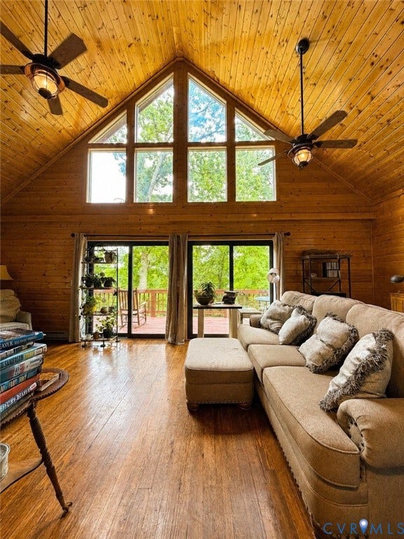 65 Cubbley Road, Hot Springs, VA 24445 Vaulted ceilings with exposed wood paneling, floor-to-ceiling geometric windows, wood-finish flooring, dual ceiling fans, and sliding glass doors