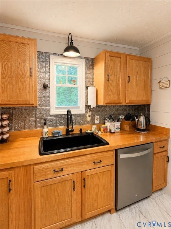65 Cubbley Road, Hot Springs, VA 24445 Kitchen featuring wood cabinetry, solid wood countertops, black composite basin sink with a matte black pull-down faucet, patterned metal tile backsplash, and stainless steel dishwasher