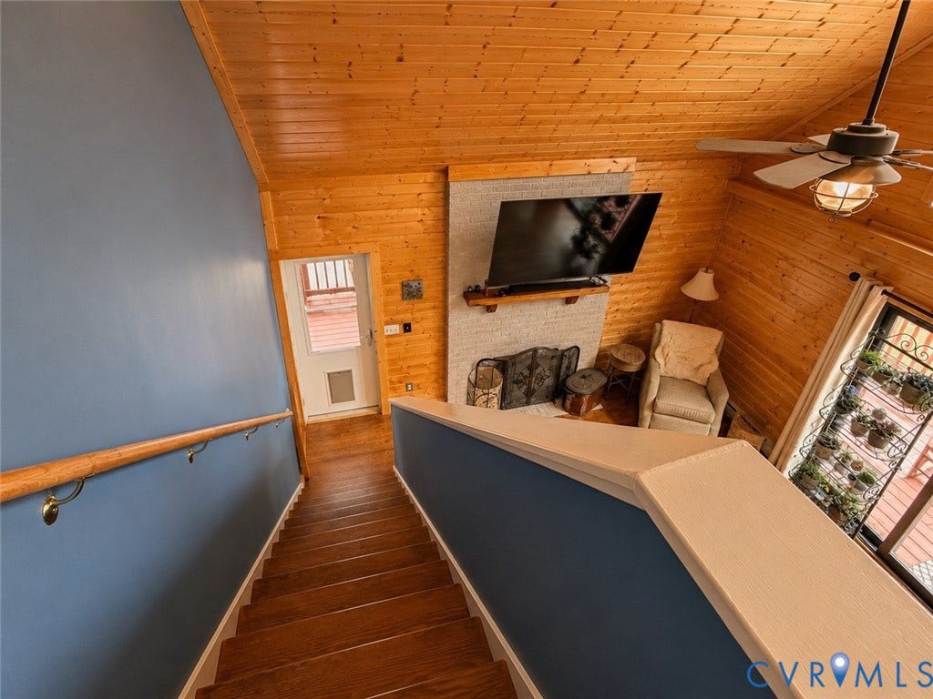 65 Cubbley Road, Hot Springs, VA 24445 Vaulted ceiling with wood-plank paneling, brick fireplace featuring a wood mantel, and wood-finish flooring