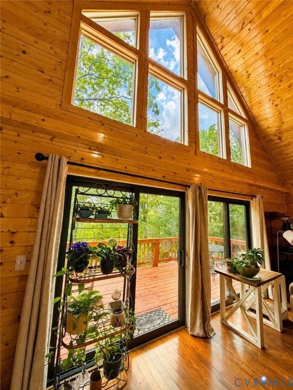 65 Cubbley Road, Hot Springs, VA 24445 Vaulted wood-paneled ceiling, large multi-pane windows, and sliding glass doors opening onto a wooden deck