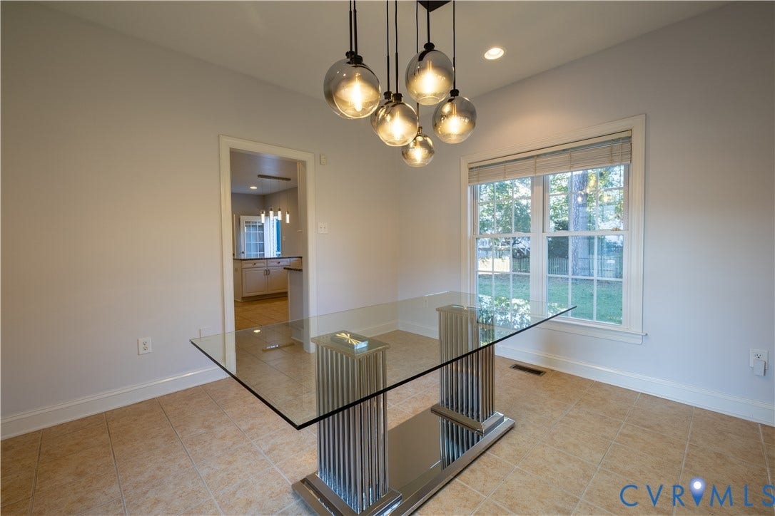 Multi-light glass globe pendant fixture, dual-pane window with grid muntins, and tiled flooring