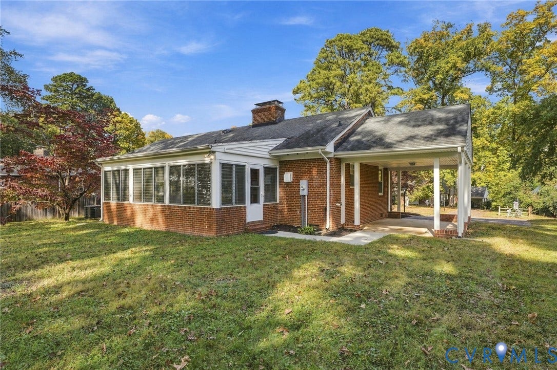7506 N Pinehill Drive, Henrico, VA 23228 Brick exterior featuring a multi-windowed sunroom, a covered carport, and a masonry chimney