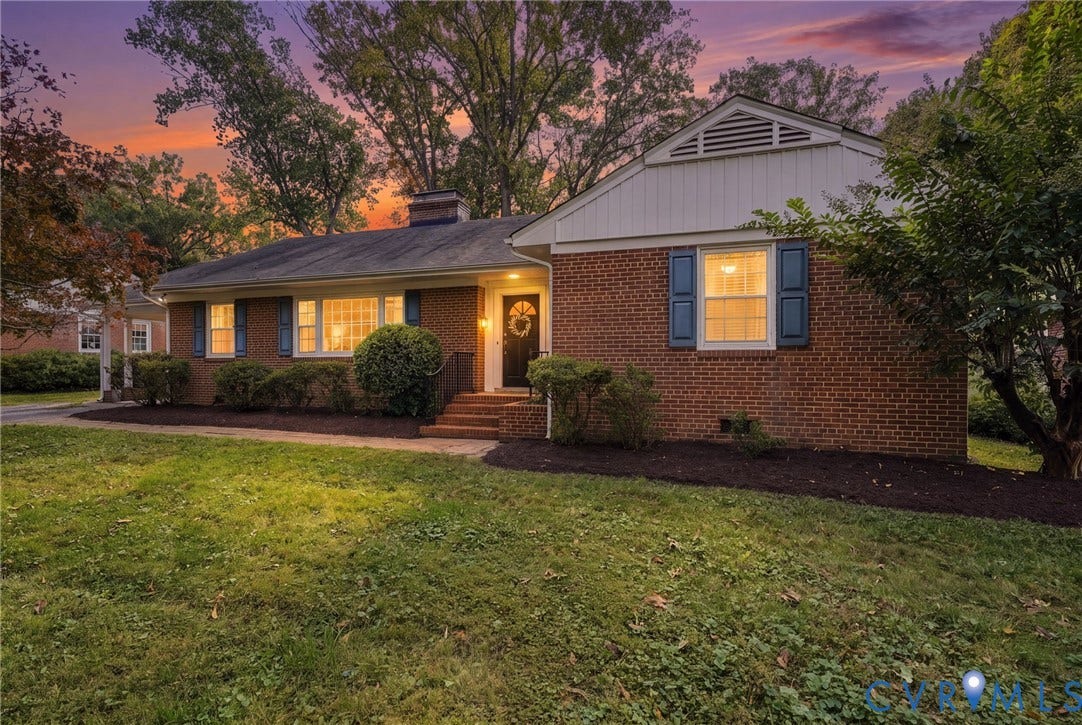 7506 N Pinehill Drive, Henrico, VA 23228 Traditional brick exterior featuring white vertical siding, dark shutters, a front chimney, and a multi-pane front door