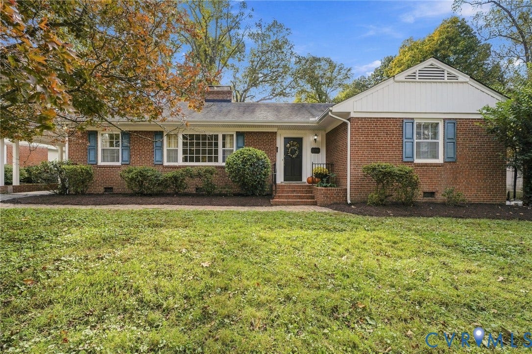 7506 N Pinehill Drive, Henrico, VA 23228 Traditional brick exterior featuring white paneled shutters, a chimney, and a gable roofline with decorative siding