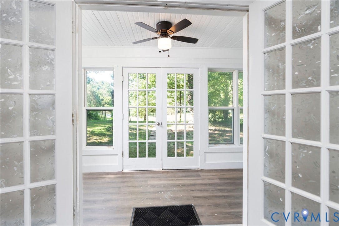 14043 Jefferson Highway, Louisa, VA 23024 Sunroom featuring wood-finish flooring, white beadboard ceiling, ceiling fan with integrated lighting, and multiple French doors with glass panes