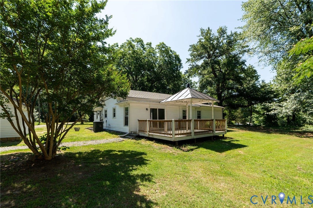 14043 Jefferson Highway, Louisa, VA 23024 Rear exterior featuring a wood deck, metal-roofed gazebo, siding, and mature trees on a lawn
