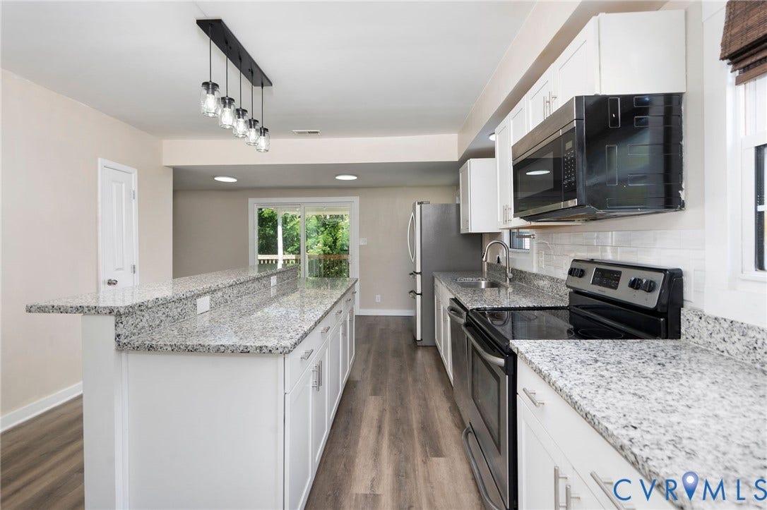14043 Jefferson Highway, Louisa, VA 23024 Kitchen featuring white cabinetry, stone countertops, stainless steel appliances, a multi-pendant light fixture, and wood-finish flooring