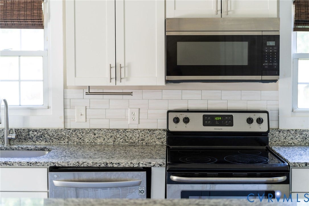 14043 Jefferson Highway, Louisa, VA 23024 Kitchen featuring stone countertops, white cabinetry, subway tile backsplash, and stainless steel appliances