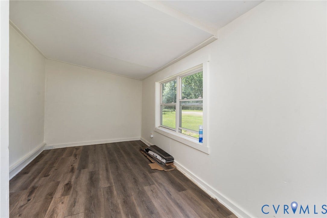 14043 Jefferson Highway, Louisa, VA 23024 Neutral-toned interior space featuring wood-finish flooring and a multi-pane window