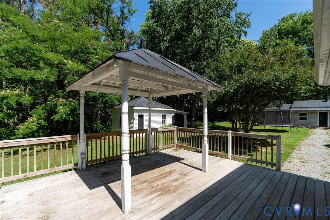 14043 Jefferson Highway, Louisa, VA 23024 Elevated wood deck featuring a covered gazebo with a metal roof and painted wooden support columns, bordered by a wooden railing