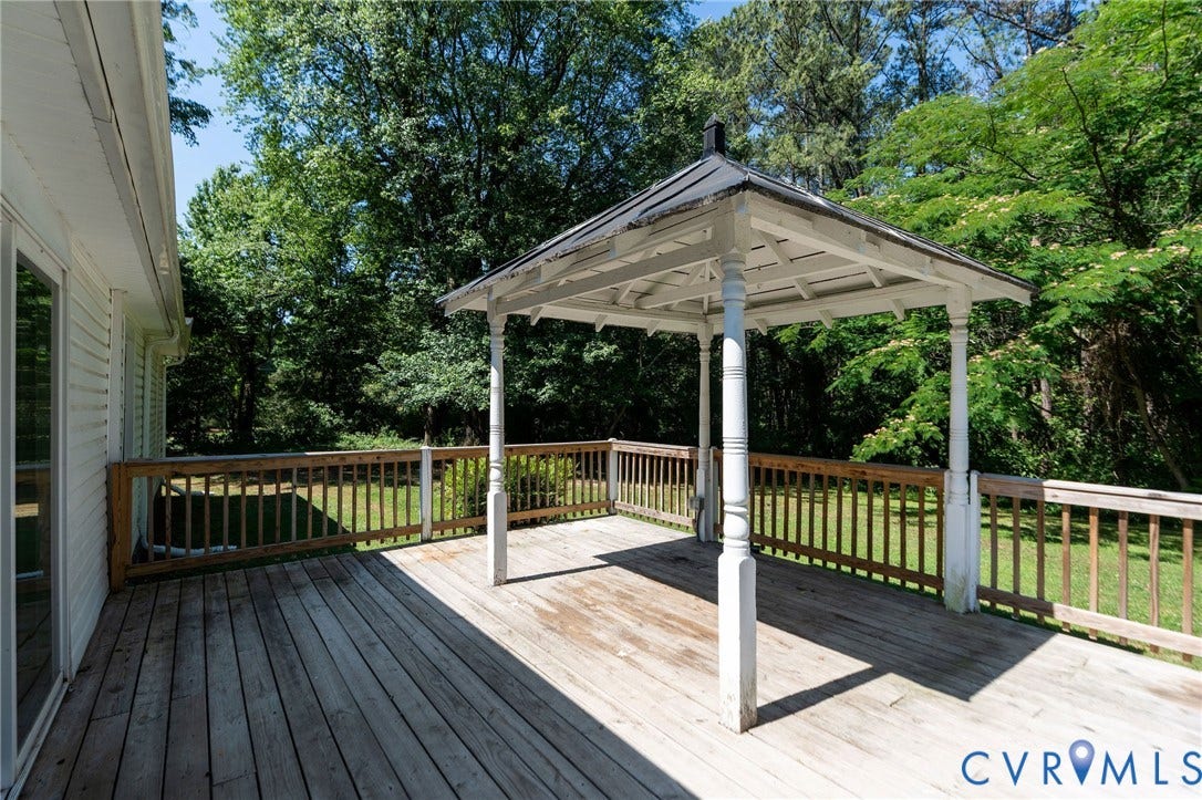 14043 Jefferson Highway, Louisa, VA 23024 Outdoor wooden deck featuring a covered gazebo, wooden railings, and mature surrounding trees