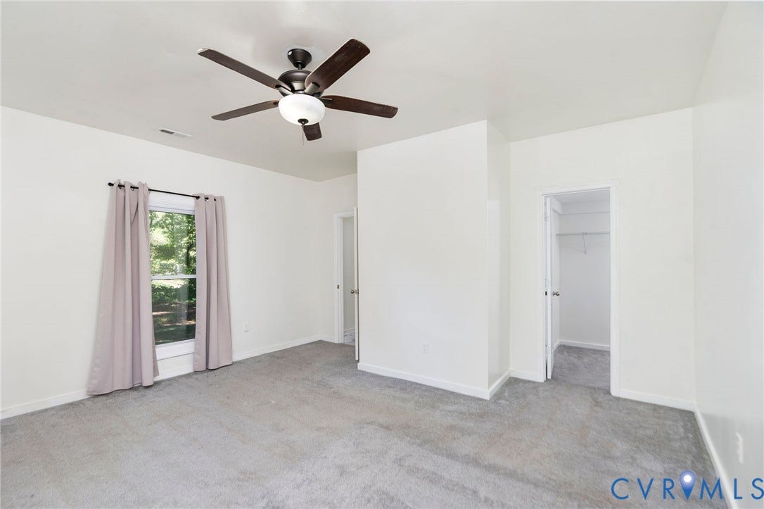 14043 Jefferson Highway, Louisa, VA 23024 Room featuring neutral-toned carpeting, a ceiling fan with integrated lighting, and a walk-in closet