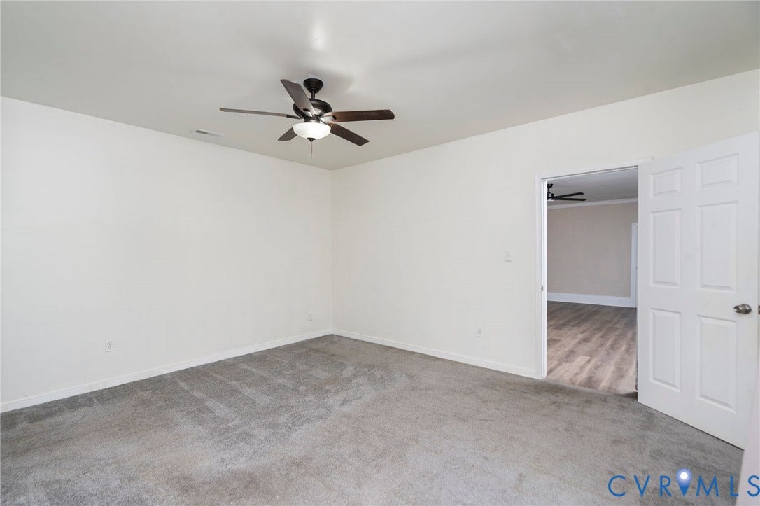 14043 Jefferson Highway, Louisa, VA 23024 Interior space featuring neutral-toned carpeting, a ceiling fan with integrated lighting, and a multi-panel interior door