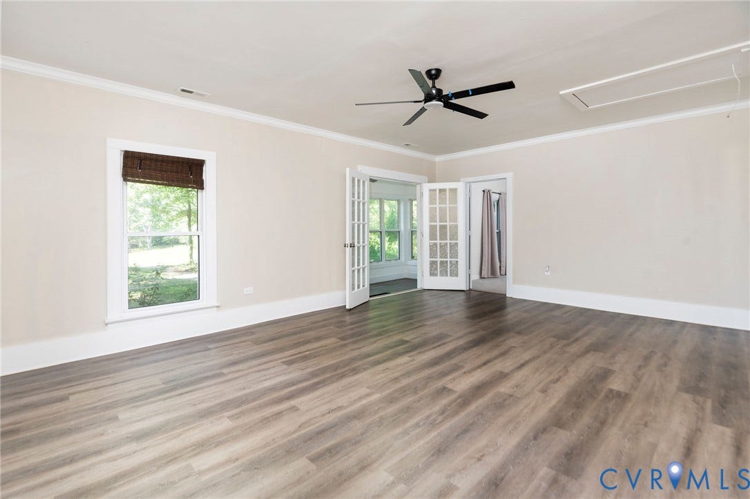 14043 Jefferson Highway, Louisa, VA 23024 Wood-finish flooring, crown molding, double French doors, ceiling fan with integrated lighting, and multi-pane window