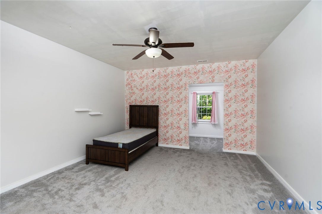 14043 Jefferson Highway, Louisa, VA 23024 Room featuring carpeted flooring, decorative wallpaper accent wall, wall-mounted shelving, and a ceiling-mounted light fixture with a fan
