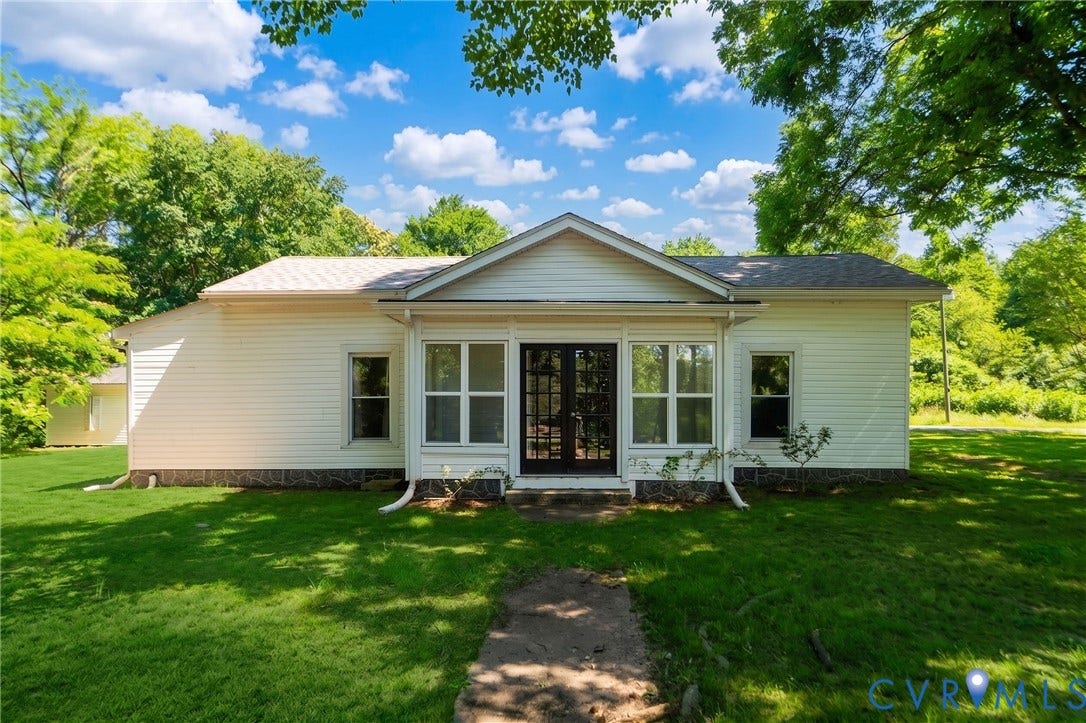 14043 Jefferson Highway, Louisa, VA 23024 Single-story residence featuring light-colored horizontal siding, a gabled roofline, and double glass-paned entry doors centered between large multi-pane windows