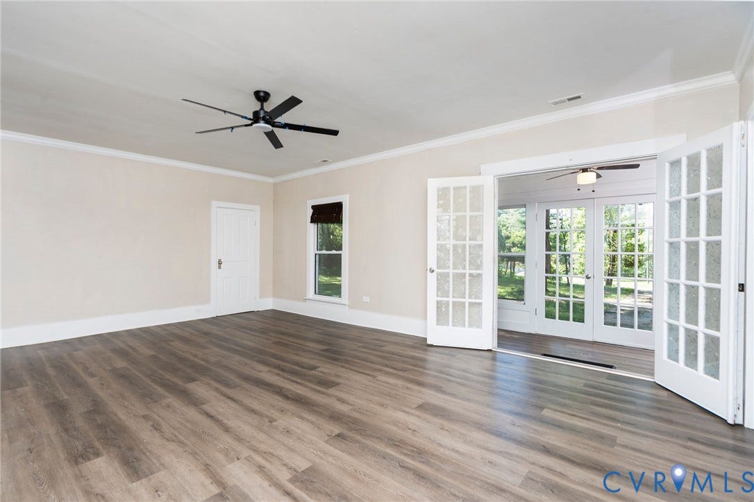 14043 Jefferson Highway, Louisa, VA 23024 Interior space featuring wood-finish flooring, white French doors, crown molding, and a multi-blade ceiling fan
