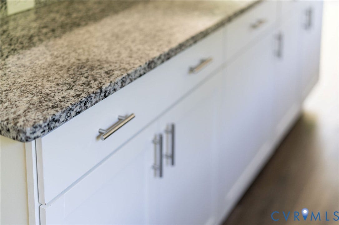 14043 Jefferson Highway, Louisa, VA 23024 White shaker-style cabinetry with satin nickel bar pulls and a neutral-toned stone countertop