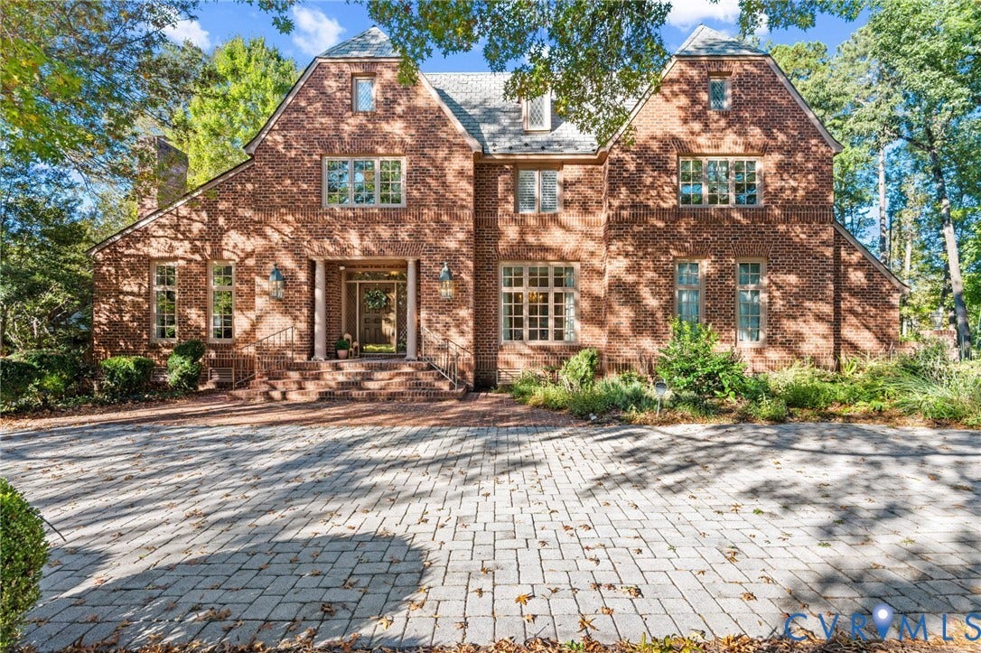 11429 Barrington Bridge Court, Henrico, VA 23233 Two-story brick exterior featuring a steeply pitched roof, multi-pane windows, a columned entryway, and a paved stone driveway