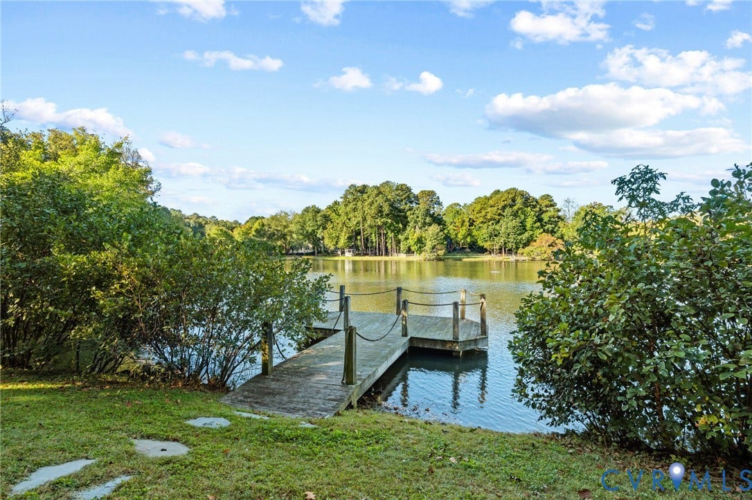 11429 Barrington Bridge Court, Henrico, VA 23233 Waterfront property featuring a wooden pier with rope railing, manicured lawn, and mature trees