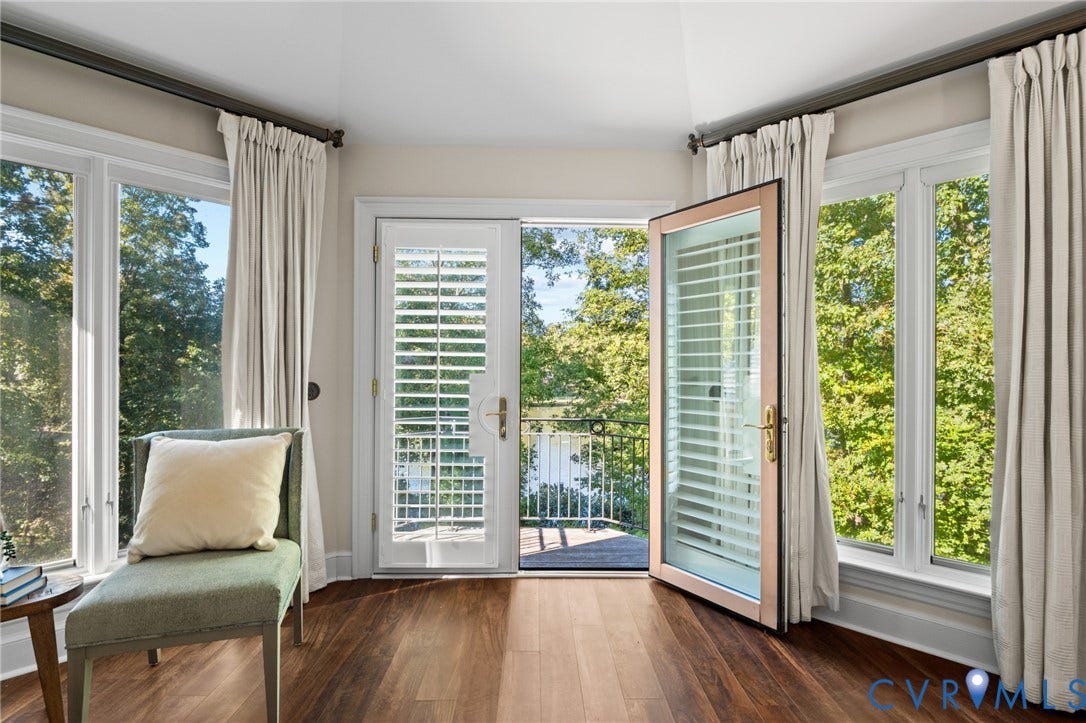11429 Barrington Bridge Court, Henrico, VA 23233 Multi-paneled bay windows, wood-finish flooring, and glass-paneled exterior door opening to a balcony with metal railing