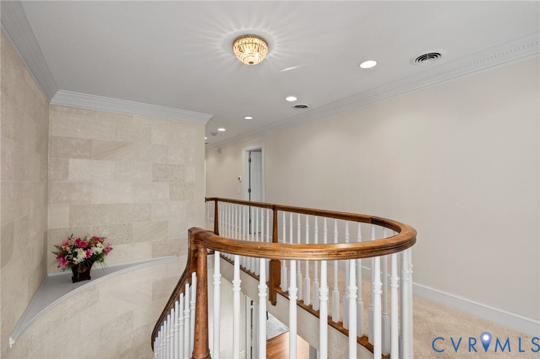 11429 Barrington Bridge Court, Henrico, VA 23233 Curved staircase featuring a wooden handrail and white balusters, stone-tile accent wall, recessed lighting, and crown molding