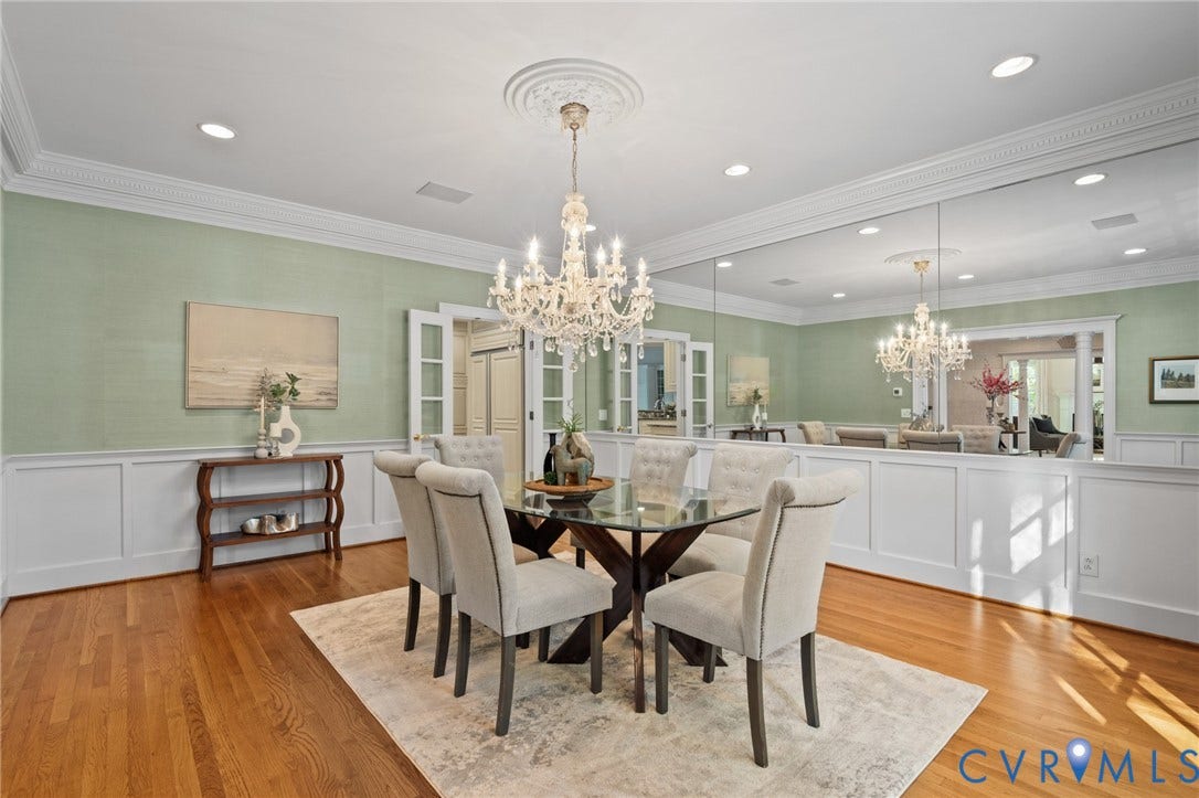 11429 Barrington Bridge Court, Henrico, VA 23233 Formal dining space featuring intricate crown molding, extensive wall wainscoting, polished wood-finish flooring, a crystal chandelier with a decorative ceiling medallion, and a large-scale wall mirror