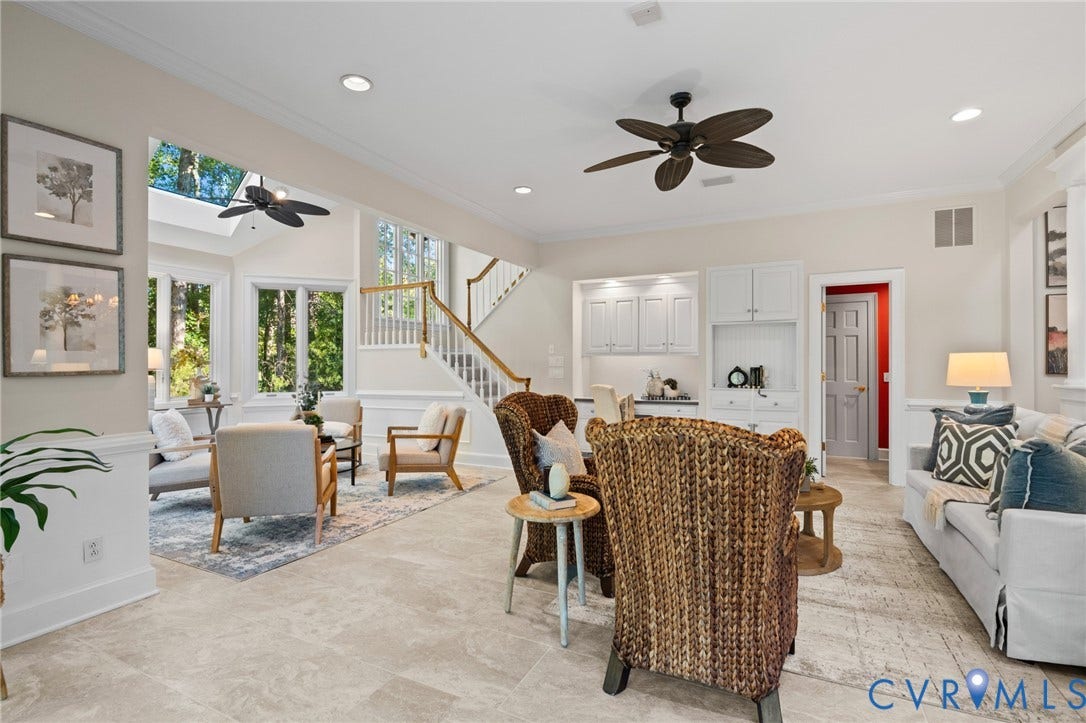 11429 Barrington Bridge Court, Henrico, VA 23233 Open-concept interior featuring large-format tile flooring, recessed lighting, built-in cabinetry, a multi-paneled staircase with a wooden handrail, and oversized windows with a transom