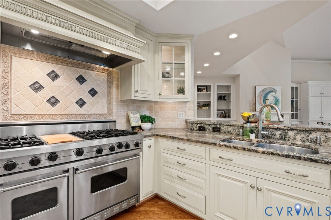 11429 Barrington Bridge Court, Henrico, VA 23233 Kitchen featuring a stainless steel dual-oven gas range with a decorative tile backsplash, stone countertops, custom cabinetry with glass-front display sections, and a dual-basin undermount sink
