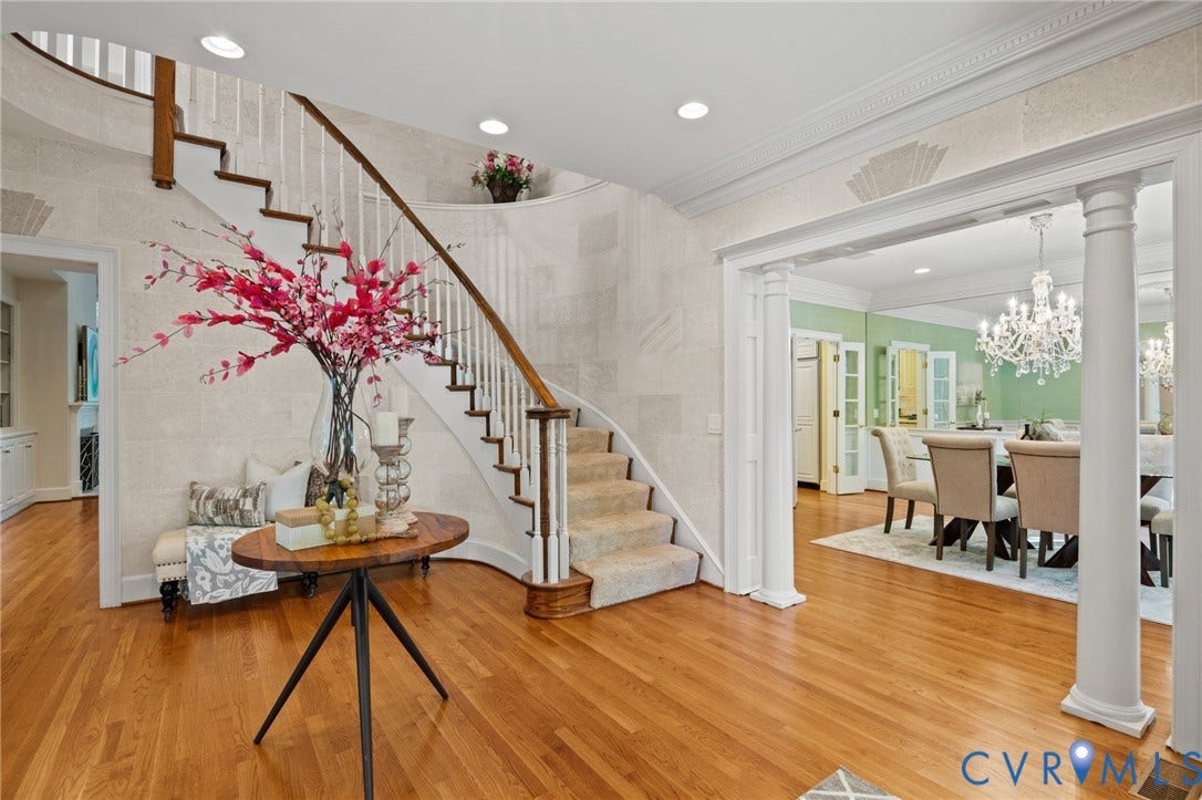 11429 Barrington Bridge Court, Henrico, VA 23233 Foyer featuring a curved staircase with a wood handrail, hardwood flooring, recessed lighting, crown molding, and columns