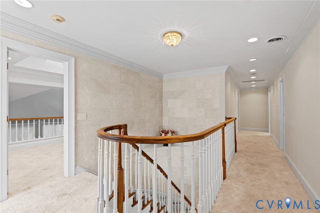 11429 Barrington Bridge Court, Henrico, VA 23233 Curved staircase featuring a wooden handrail and white balusters, stone-tile accent wall, crown molding, and recessed lighting