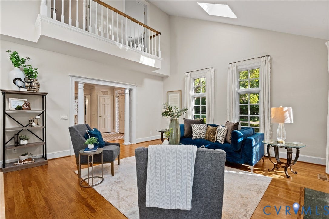 11429 Barrington Bridge Court, Henrico, VA 23233 Vaulted ceiling featuring a skylight, wood-finish flooring, and a second-level railed gallery with white balusters and wood handrail