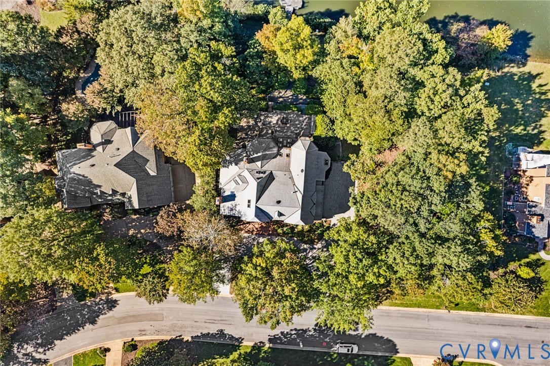 11429 Barrington Bridge Court, Henrico, VA 23233 Aerial perspective featuring a multi-gabled roofline, expansive tree canopy, paved driveway, and water frontage