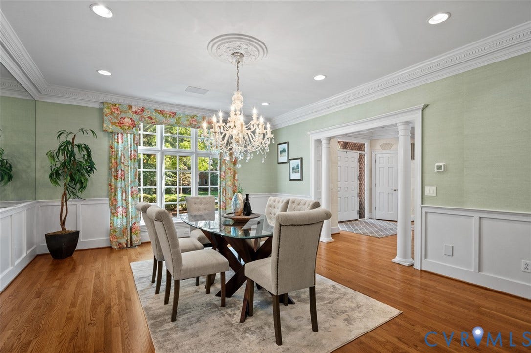 11429 Barrington Bridge Court, Henrico, VA 23233 Dining room featuring hardwood flooring, wainscoting, an ornate ceiling medallion, crystal chandelier, and classical columns