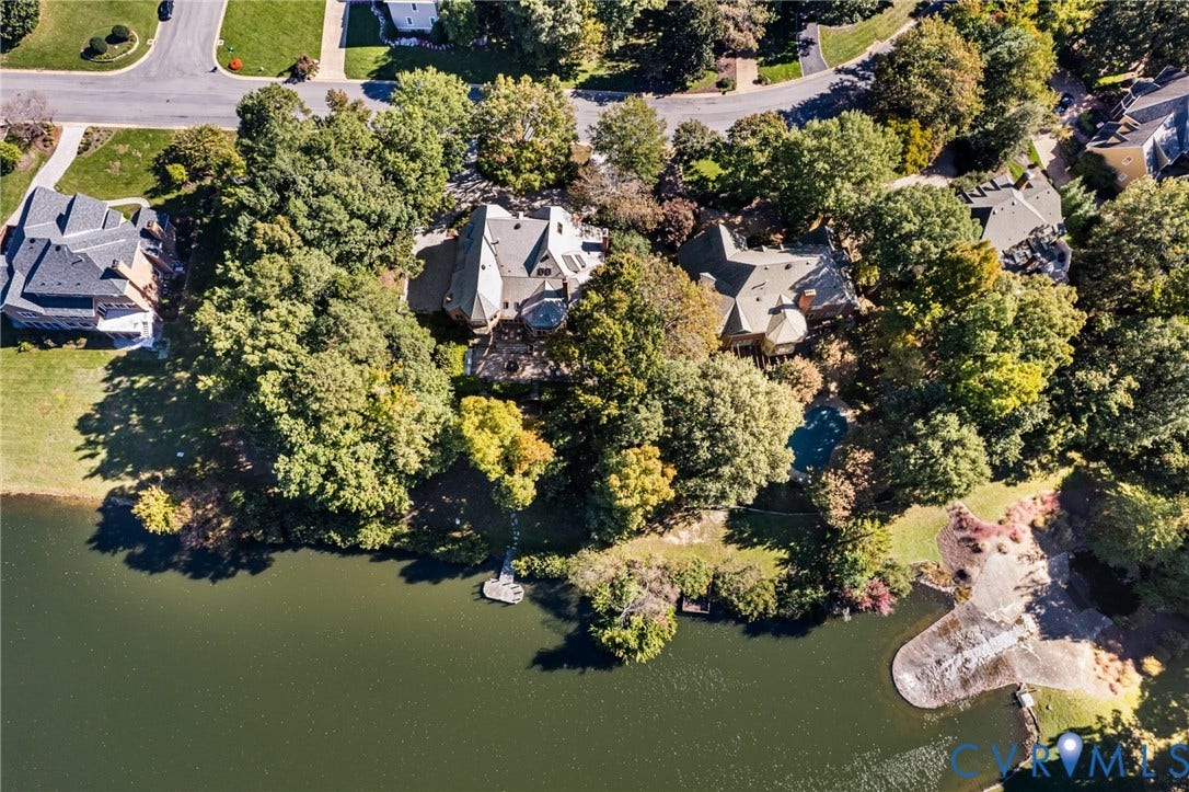 11429 Barrington Bridge Court, Henrico, VA 23233 Aerial perspective of a multi-level residence featuring a shoreline position, a private dock, an in-ground swimming pool, and mature wooded landscaping