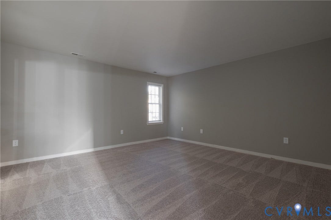 7009 Summers Trace Court, Chesterfield, VA 23832 Primary Bedroom with Neutral-toned interior space featuring wall-to-wall carpeting and a single-pane grid window