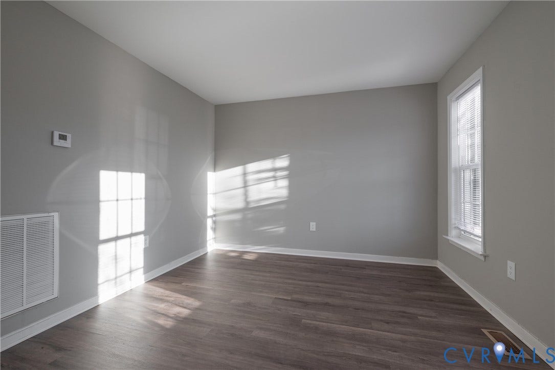 7009 Summers Trace Court, Chesterfield, VA 23832 Living Room featuring neutral-toned wall paint, new flooring, and a single double-hung window with built-in blinds