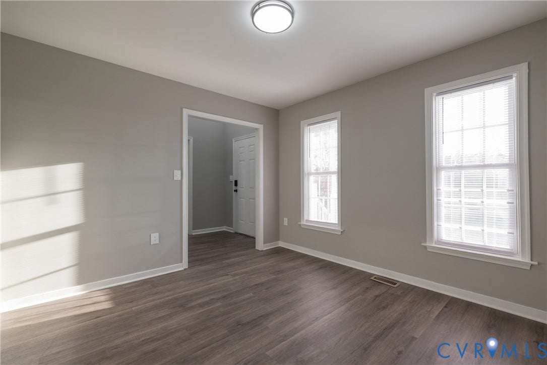 7009 Summers Trace Court, Chesterfield, VA 23832 Formal Dining Room with new flooring, dual windows with blinds, and a flush-mount overhead light fixture