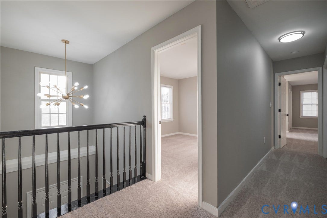 7009 Summers Trace Court, Chesterfield, VA 23832 Upper Hallway looks over a 2 Story Foyer with spindle railing, multi-arm sputnik-style chandelier, neutral carpeting, and multi-pane windows