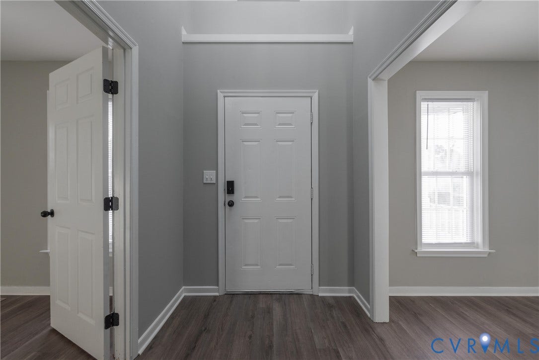 7009 Summers Trace Court, Chesterfield, VA 23832 2 Story Entrance featuring six-panel interior doors, wood-finish flooring, neutral wall paint, and a double-hung window
