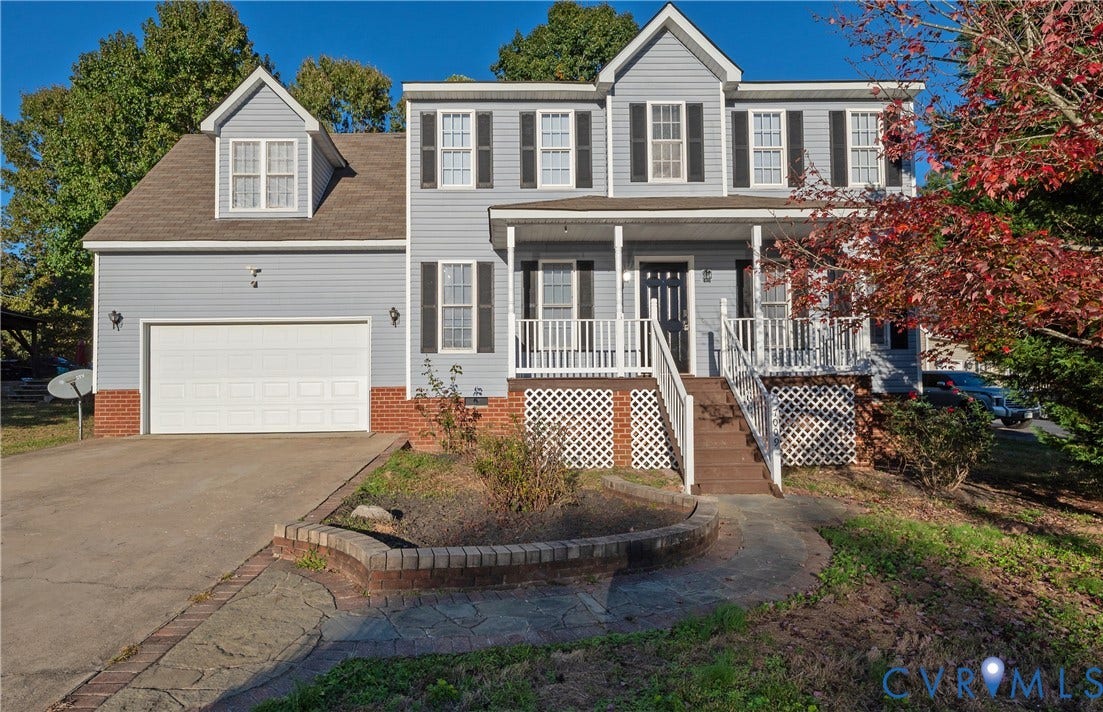 7009 Summers Trace Court, Chesterfield, VA 23832 Two-story residence featuring vinyl siding, a brick foundation, a front covered porch with railings, and a concrete driveway
